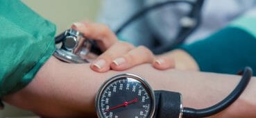 Photo of someone taking a patient's blood pressure.