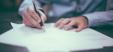 Photo of man writing.