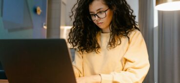 girl at a pc she could be creating a multiple short answer question exam